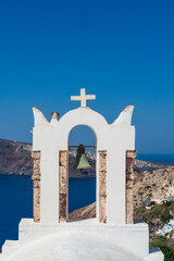 Single church bell with a view of the Agean Sea in Oia, Santorini, Greece