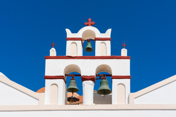 Three bells on top of a chirch in Oia, Santorini, Greece