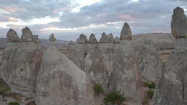 Typical fairy chimneys of Cappadocia, T&uuml;rkiye, against a dramatic sky