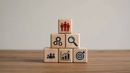 Business concept stack of wooden cubes with icons for human resources, process, and target, illustrating organizational growth and planning..png