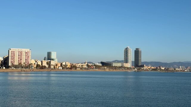 Panoramic coastal city view of Barcelona with modern skyline, calm sea and blue sky, Mediterranean travel destination and urban beach background for tourism and lifestyle content