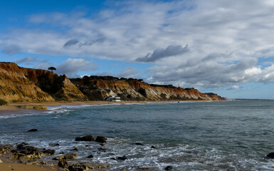 Obraz premium Aerial seascape and coastline cliffs of Praia do Barranco das Belharucas beach, in Algarve region in South Portugal. Praia do Barranco das Belharucas beach, Albufeira, Algarve, Portugal.