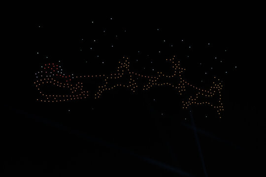 Santa Claus and Reindeer Sleigh Image Created by UAV Drone Light Show with Soft Focus and Minimal Bokeh Effect
