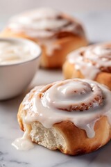 Cinnamon rolls with sweet icing dripping onto a marble surface, a delicious breakfast pastry