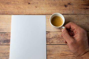 Coffee Cup And Blank Paper On Wooden Desk