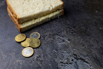 Bread And Coins On Dark Table