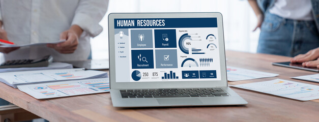 Human resources management software on computer screen helping human resources employee to manage...