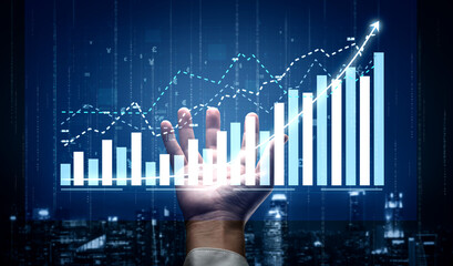 A hand reaches out towards a digital representation of financial data, showcasing growth through various charts in blue and white tones, symbolizing opportunity. Impute