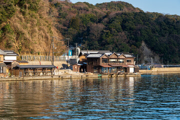 The modern architecture of the popular Ine Cafe, a waterfront coffee shop offering scenic views of the traditional Funaya boathouses in Ine Bay. Ine, Kyoto, Japan.