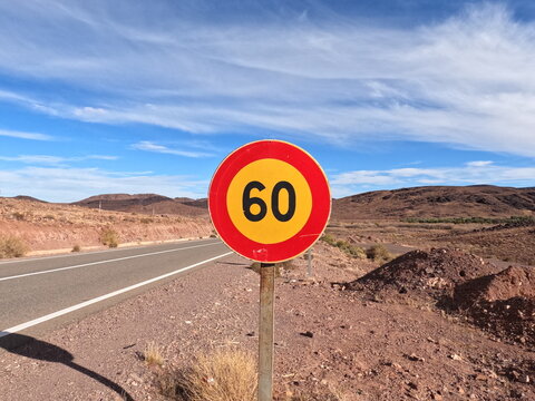 Red and yellow speed limit 60 road sign