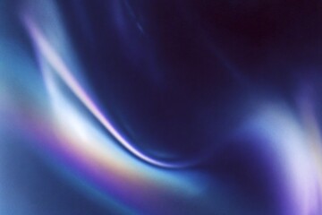 Abstract swirl of blue and purple hues creating a dreamy, fluid pattern on a dark background.