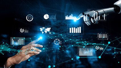 A human hand reaches toward a robotic arm in a high-tech environment. Screens display various data metrics, highlighting the fusion of human insight and advanced technology. Xenic