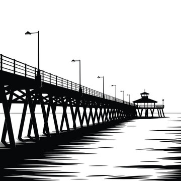 A striking black and white view of a pier extending into the ocean