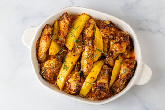 Oven-grilled chicken wings and potatoes. Turkish name: Tavuk kanat