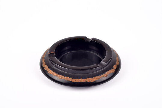 Handcrafted vintage black wooden carved ashtray isolated on the white background. Selective focus.