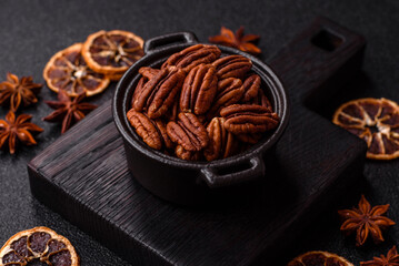 Peeled and roasted pecan nut as an ingredient for healthy food. Pecan nut as a food background