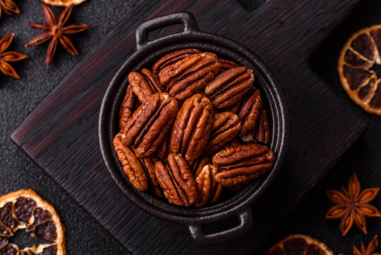 Peeled and roasted pecan nut as an ingredient for healthy food. Pecan nut as a food background