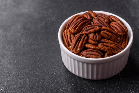 Peeled and roasted pecan nut as an ingredient for healthy food. Pecan nut as a food background