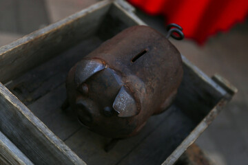 Wrought iron piggy bank for saving coins. Funny investment, business, finance and saving money concept.