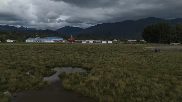Aerial Side Parallax View of Flooded River Valley Reflecting Heavy Clouds