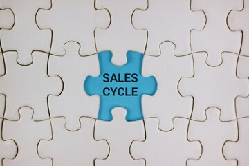 Blue Puzzle Piece With Sales Cycle Text Among White Pieces Symbolizing Business Growth and Strategy.