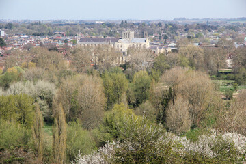 Spring landscape view over trees towards Winchester Cathedral from surrounding hills in Winchester