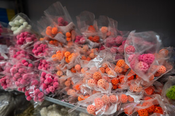 Multicolored flowers in packages in a store. 