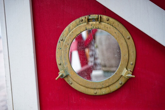 Round ship style window with shattered circular glass mirror
