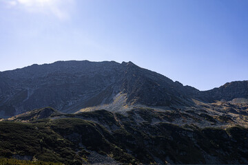 Mountain lake surrounded by rocky ridges in high Tatras landscape