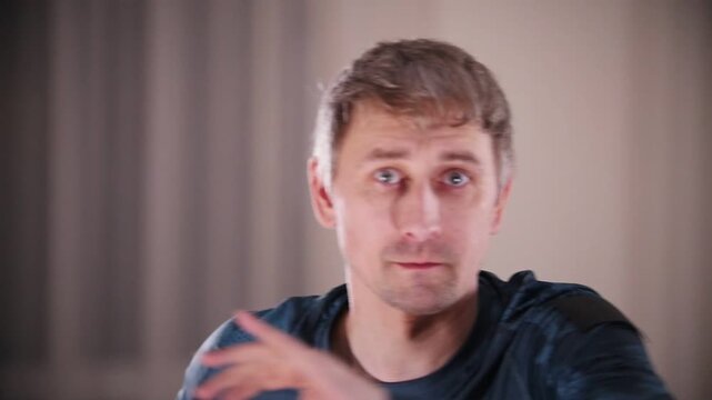 Martial arts. A man in blue clothes resting up and preparing for a sparring