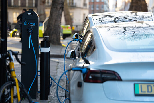 EV Charging Bay, Tesla Cars Plugged In Rapid High-Power Roadside Charging Station Connector, Electric Vehicle Charge Point, London, England, Britain