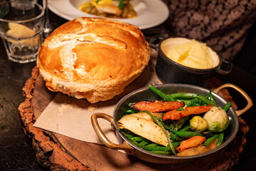 Steak and real ale pot pie, tender beef in rich ale gravy, baked in flaky pastry, with creamy clotted cream mash and fresh seasonal greens