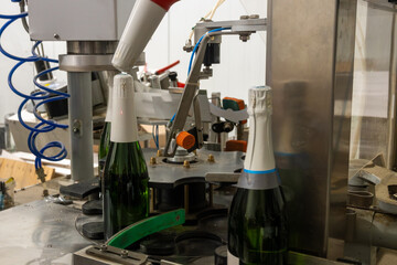 Process of putting foil on champagne bottles in caves, traditional method of production of...