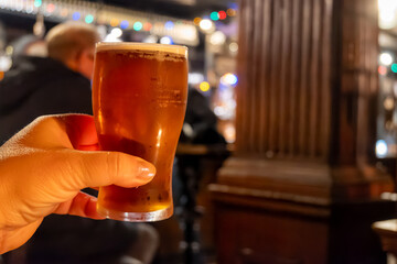 Classic London pub crawl with friends, enjoying cask ales and lively atmosphere of traditional British pubs, grasses of cask ales beer from barrels