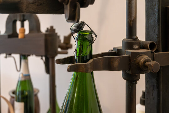Old equipment for packaging champagne bottles, caps and muselet wire cage, traditional method making champagne sparkling wine in Reims, France