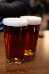 Classic London pub crawl with friends, enjoying cask ales and lively atmosphere of traditional...