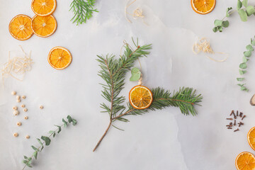 Christmas toy made from dried orange slices, wooden beads and eucalyptus leaves festive holiday interior