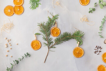 Christmas toy made from dried orange slices, wooden beads and eucalyptus leaves festive holiday interior