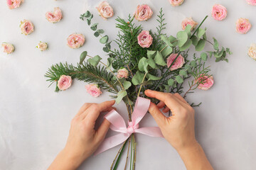 Christmas bouquet decorated with rose petals and satin ribbon &mdash; warm romantic aesthetic