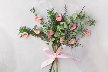 Christmas bouquet decorated with rose petals and satin ribbon &mdash; warm romantic aesthetic