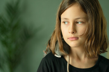 Child showing affection to her tame pet rat. The dusty gray rodent is perched on her neck. Concept of caring for small animals and pets.