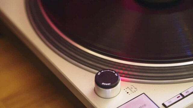 4K slow motion footage of spinning vinyl record. Retro turntable working, playing music. Close up top view shot.
