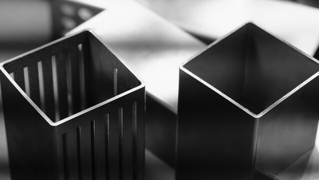 Square metal tubes cut by metal cutting machines or plasma laser machines, industrial technology concept background