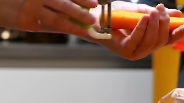 Close-up of hands peeling a fresh, vibrant orange carrot with a metal peeler on a clean white background. Concept of healthy eating, cooking, and food preparation.