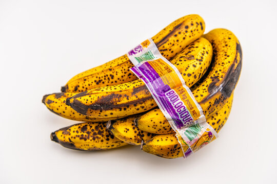 Naples, USA - May 4, 2022: Del Monte ripe banana bananas bunch, overripe food product macro closeup on white background