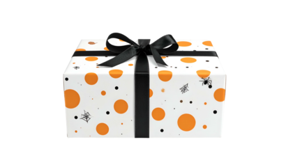 A wrapped gift box with Halloween-themed white paper, orange spots, spiders, black ribbon