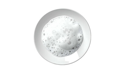 Overhead view of a white ceramic plate with a textured, bubbly white soap or foam