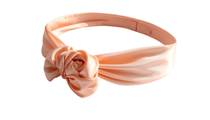Close-up of a blush-colored satin headband with a floral knot detail