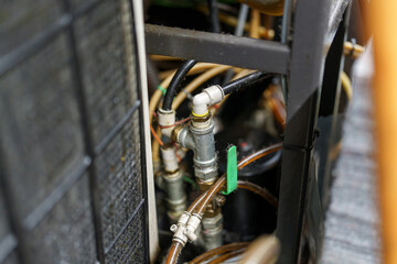 Close view of plumbing system with pipes and fittings in an industrial setting during daylight hours