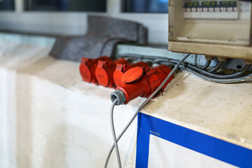 Electrical outlets and power distribution setup in a workshop display at early evening in a facility